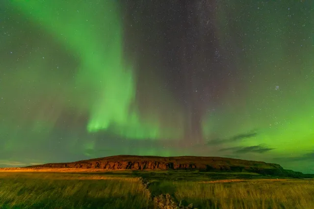 Northern lights over Ekkerøy bird rock at 70 degrees latitude